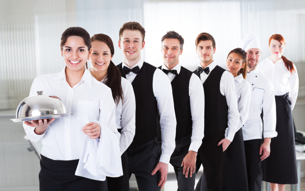 Various employees from different departments in the hotel stand in a row